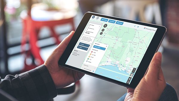 Person holding a laptop displaying outage map