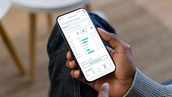 Person holding a phone looking at the app