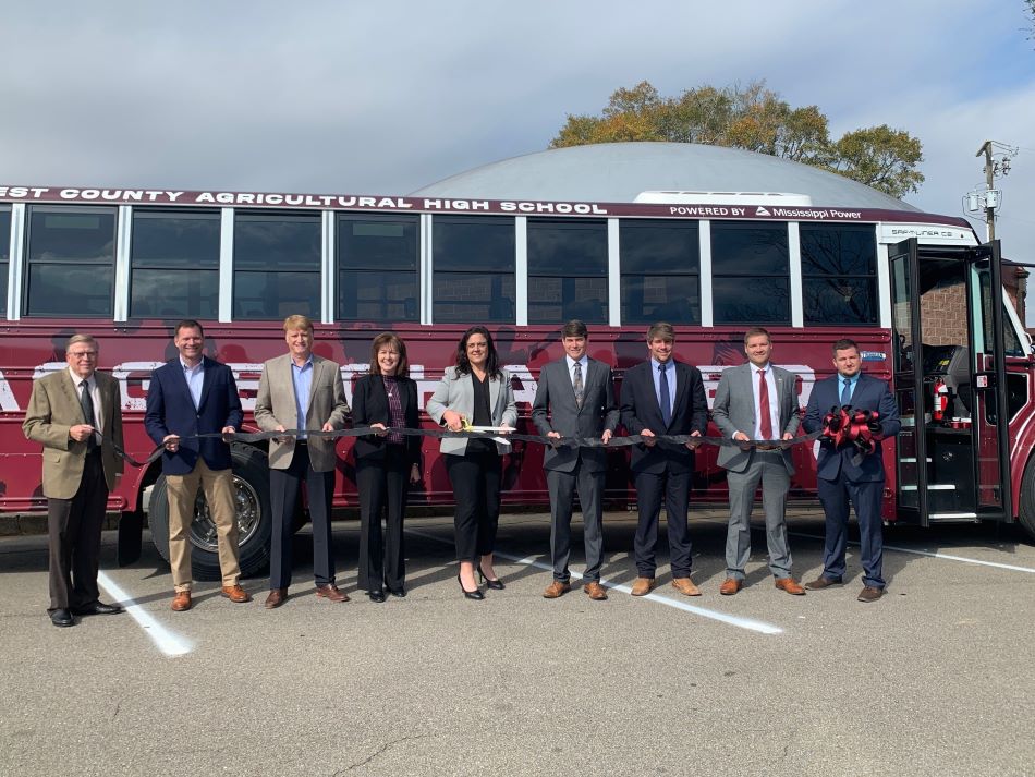 Officials from Forrest County Agricultural High School and Mississippi Power cut the ribbon the state's first all electric school bus.