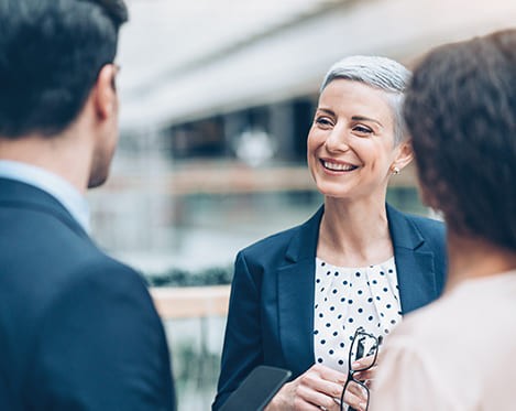 Business woman talking to business people