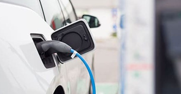 White battery powered Tesla is being charged 