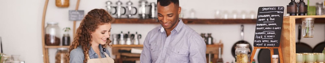 Man and woman in shop looking at tablet