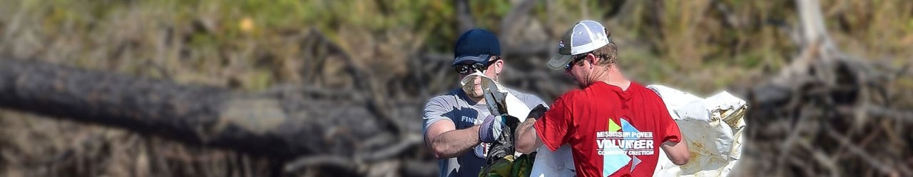 Mississippi Power employees cleaning the river