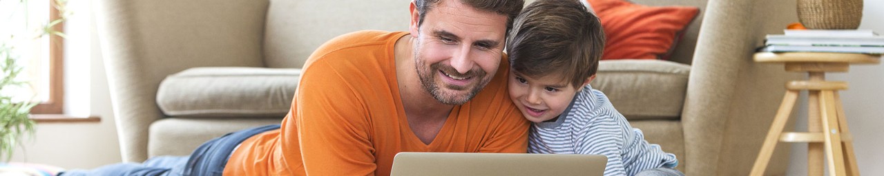 Father and son looking at computer