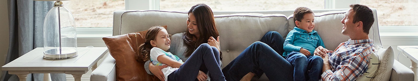 Family of Four Relaxing on Couch