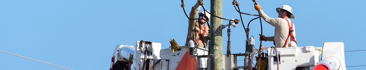 men working to restore power lines