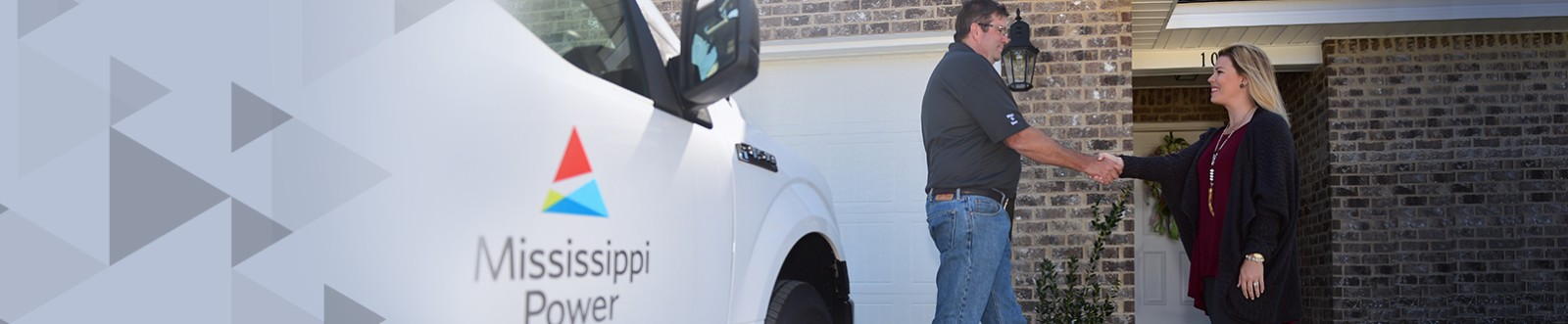 Woman talking to technician outside near air conditioner unit