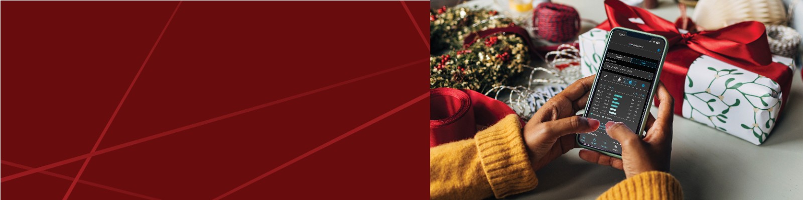 Woman looking her mobile phone screen next to Christmas decorations