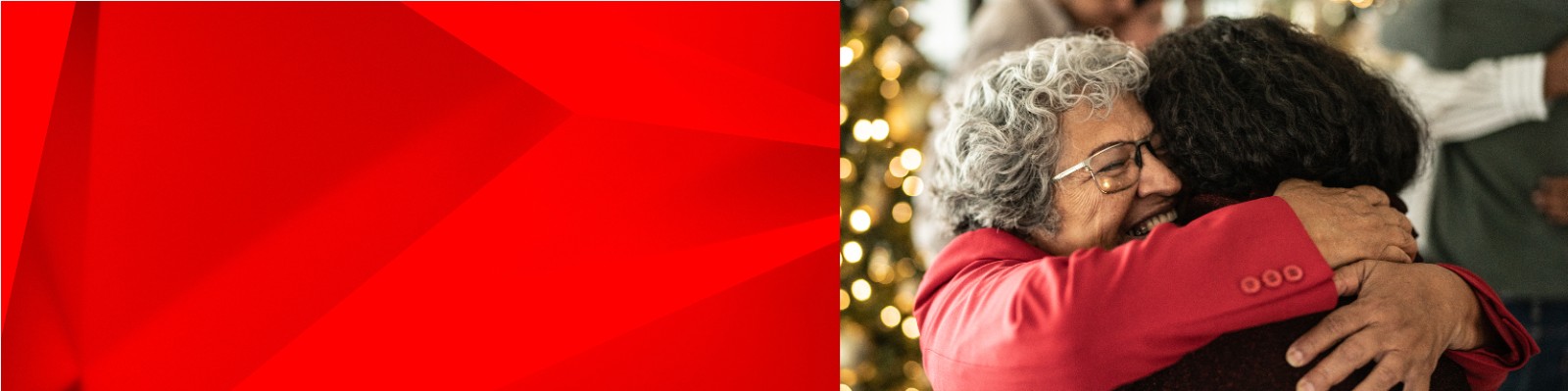Woman hugging her grandma in front of a Christmas tree