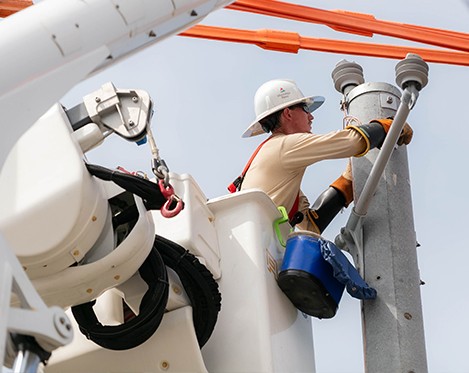 Line workers working to fix a transmission line