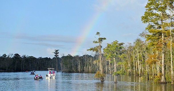 River with boats and rainbow