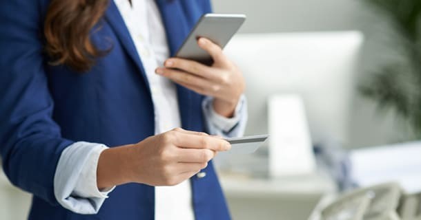 Woman taking picture of credit card