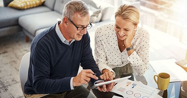 Couple observing billing options on a tablet 