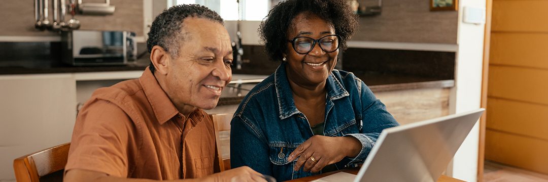 Senior couple looking at their laptop