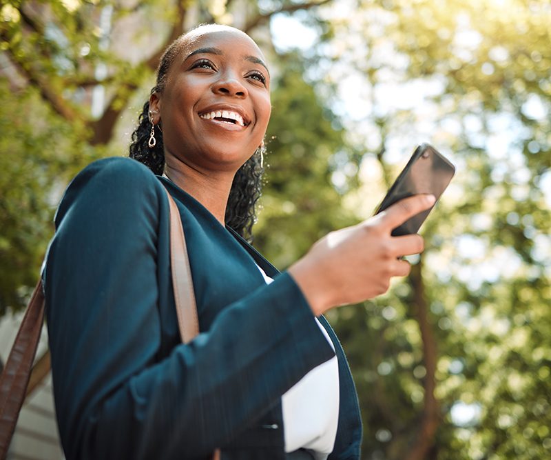 Woman smiling with smart phone in her hand