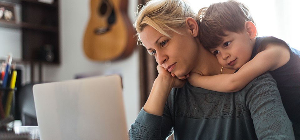 woman and child looking at computer
