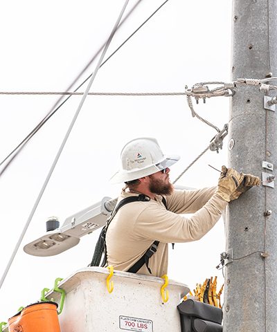 Lineman working on a concrete power distribution pole