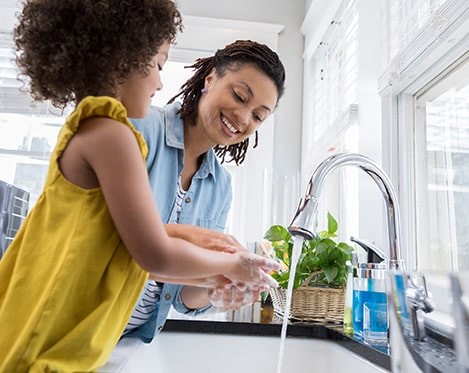 mother and daughter washing dishes